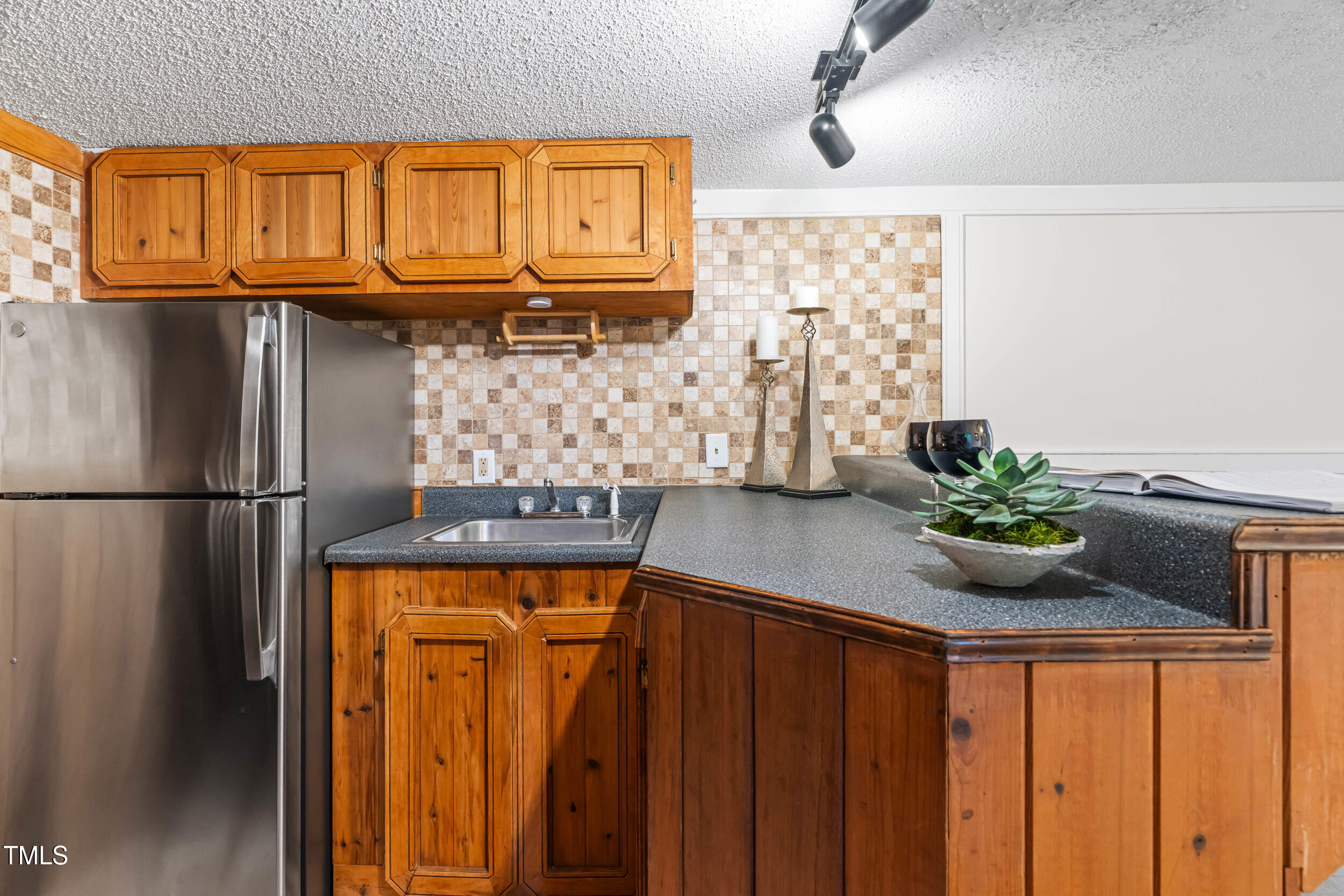 105 Firewood Circle Raleigh, NC 27607 - Photo 34 of 50 a kitchen with stainless steel appliances granite countertop a refrigerator and a sink