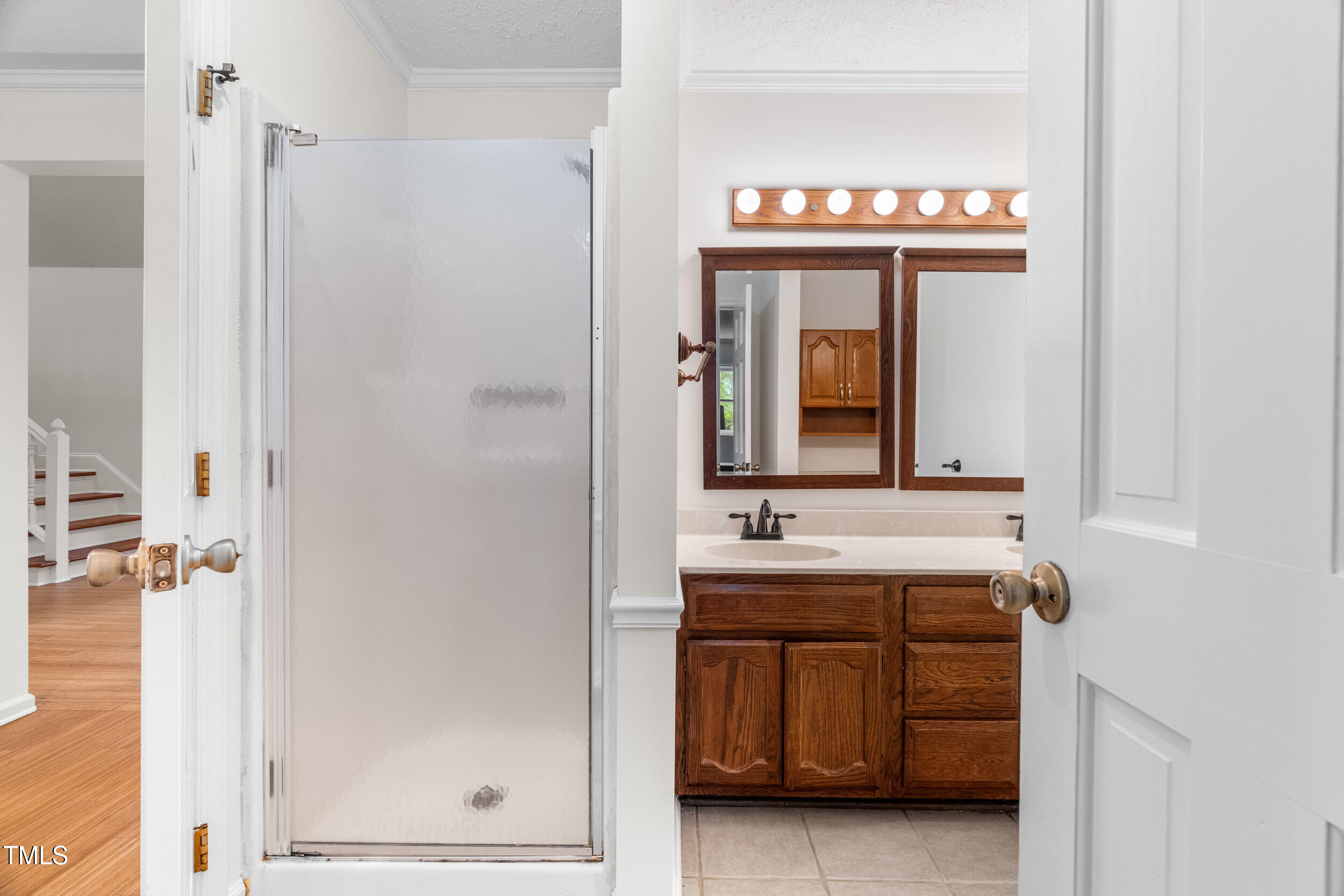 105 Firewood Circle Raleigh, NC 27607 - Photo 10 of 50 a bathroom with a sink a mirror and a shower