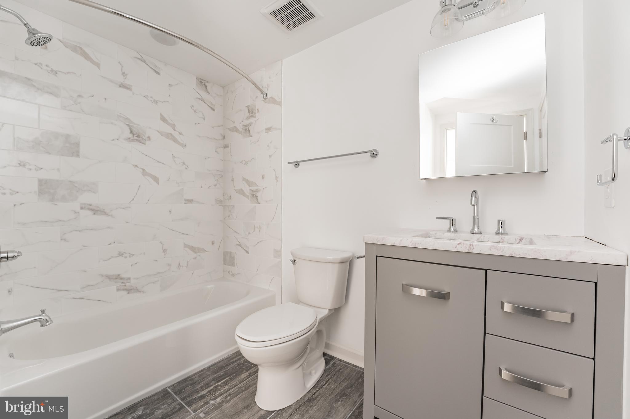 6649 Ridge Avenue, Unit A118 Philadelphia, PA 19128 - Photo 5 of 9 a bathroom with a sink a toilet and shower
