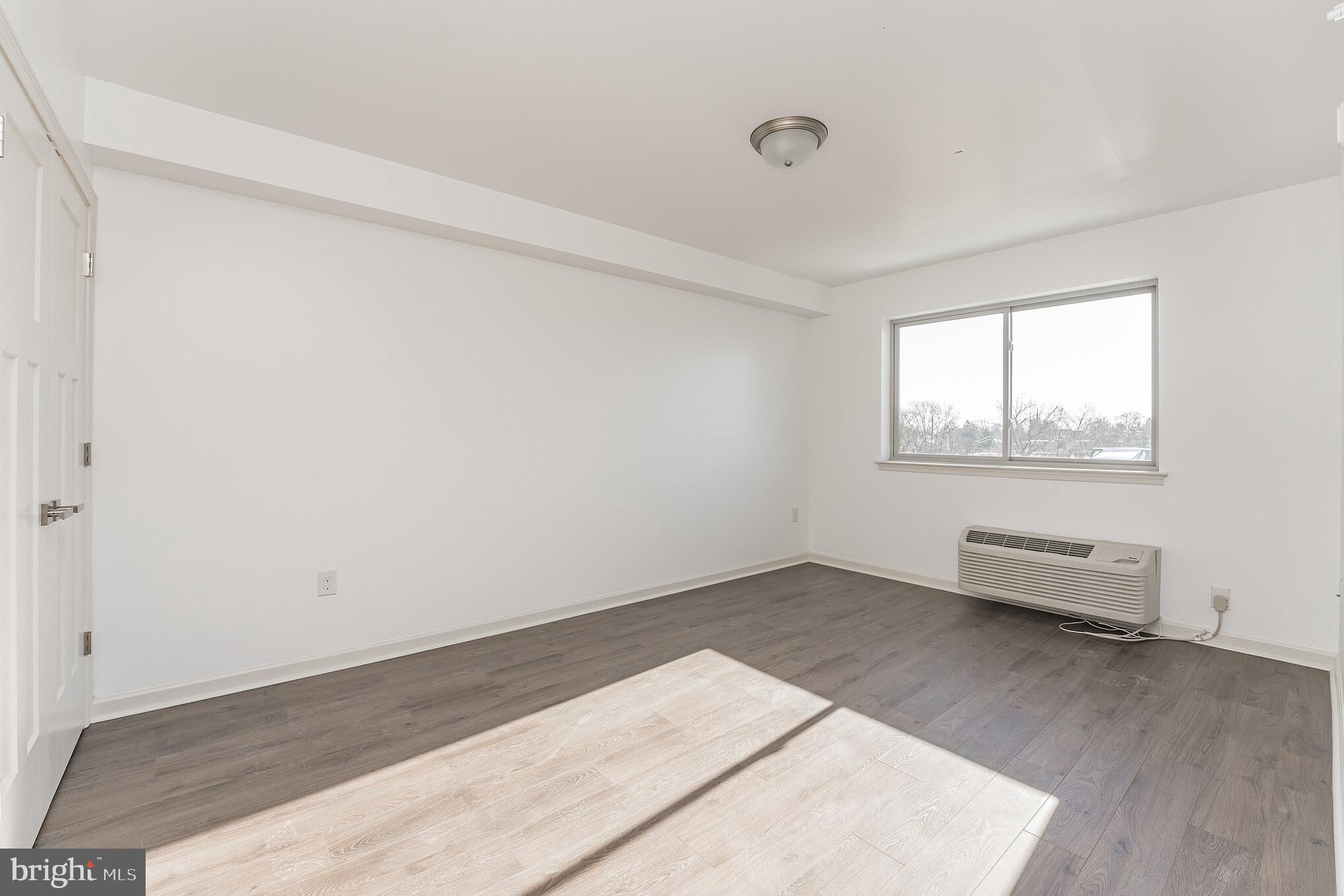 6649 Ridge Avenue, Unit A118 Philadelphia, PA 19128 - Photo 6 of 9 an empty room with windows