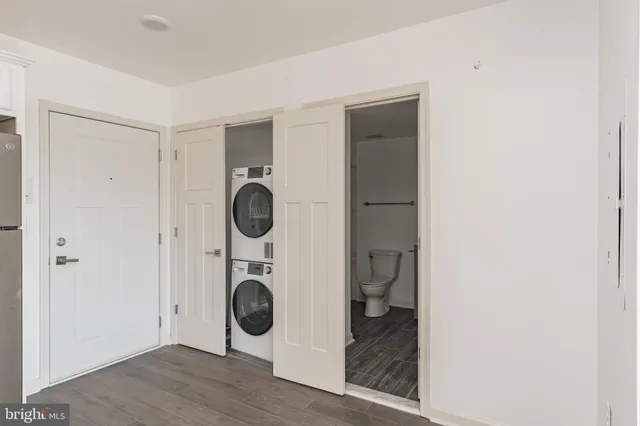 a room with wooden floor and white door