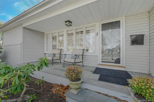 a garden with a table and chair and potted plants