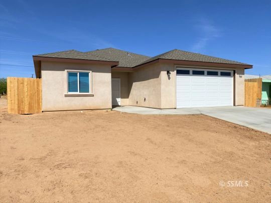1517 Mayo Street Ridgecrest, CA 93555 - Photo 1 of 32 a view of garage with a small yard