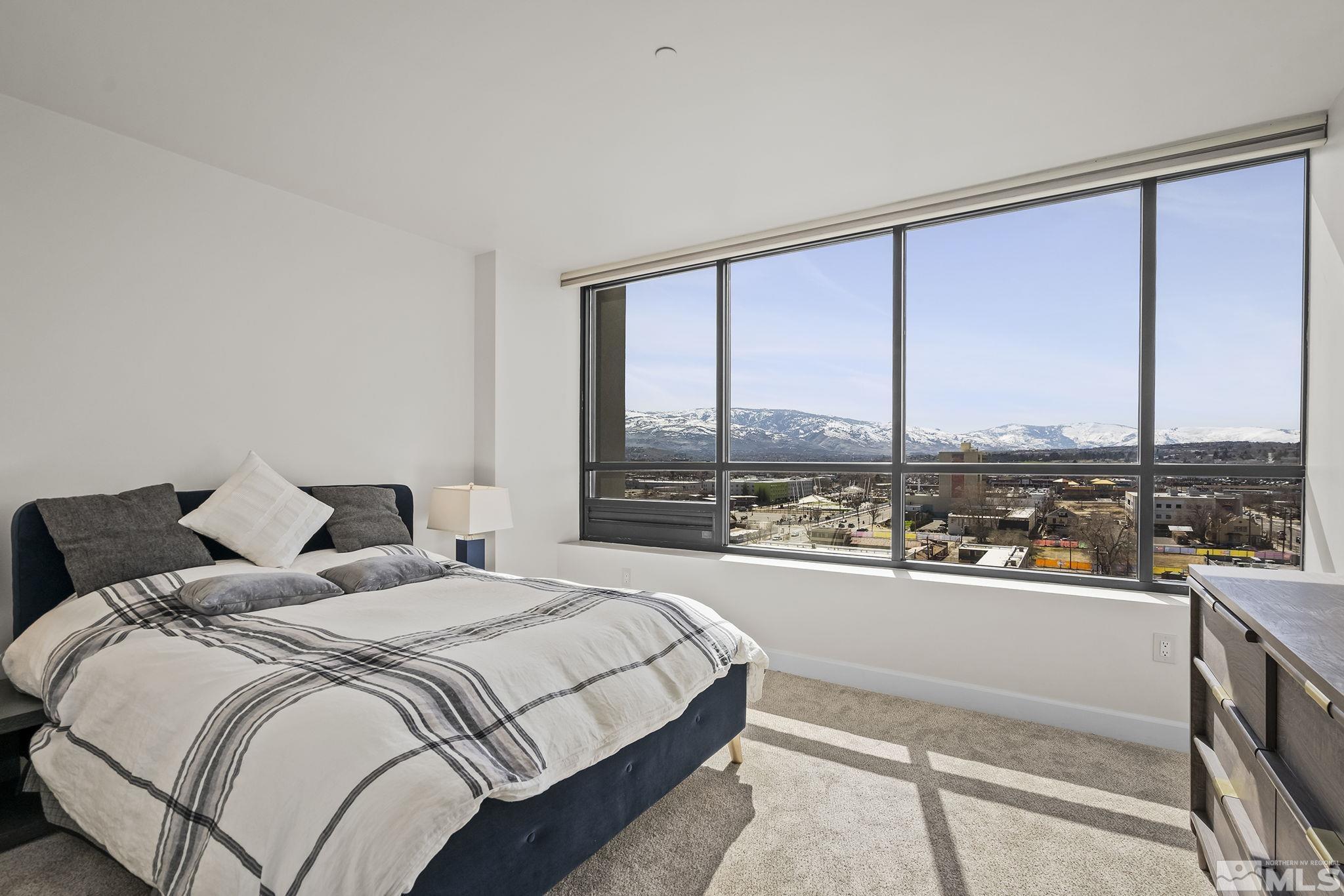 450 North Arlington Avenue, Unit 1207 Reno, NV 89503 - Photo 14 of 22 a bedroom with a large window and a bed
