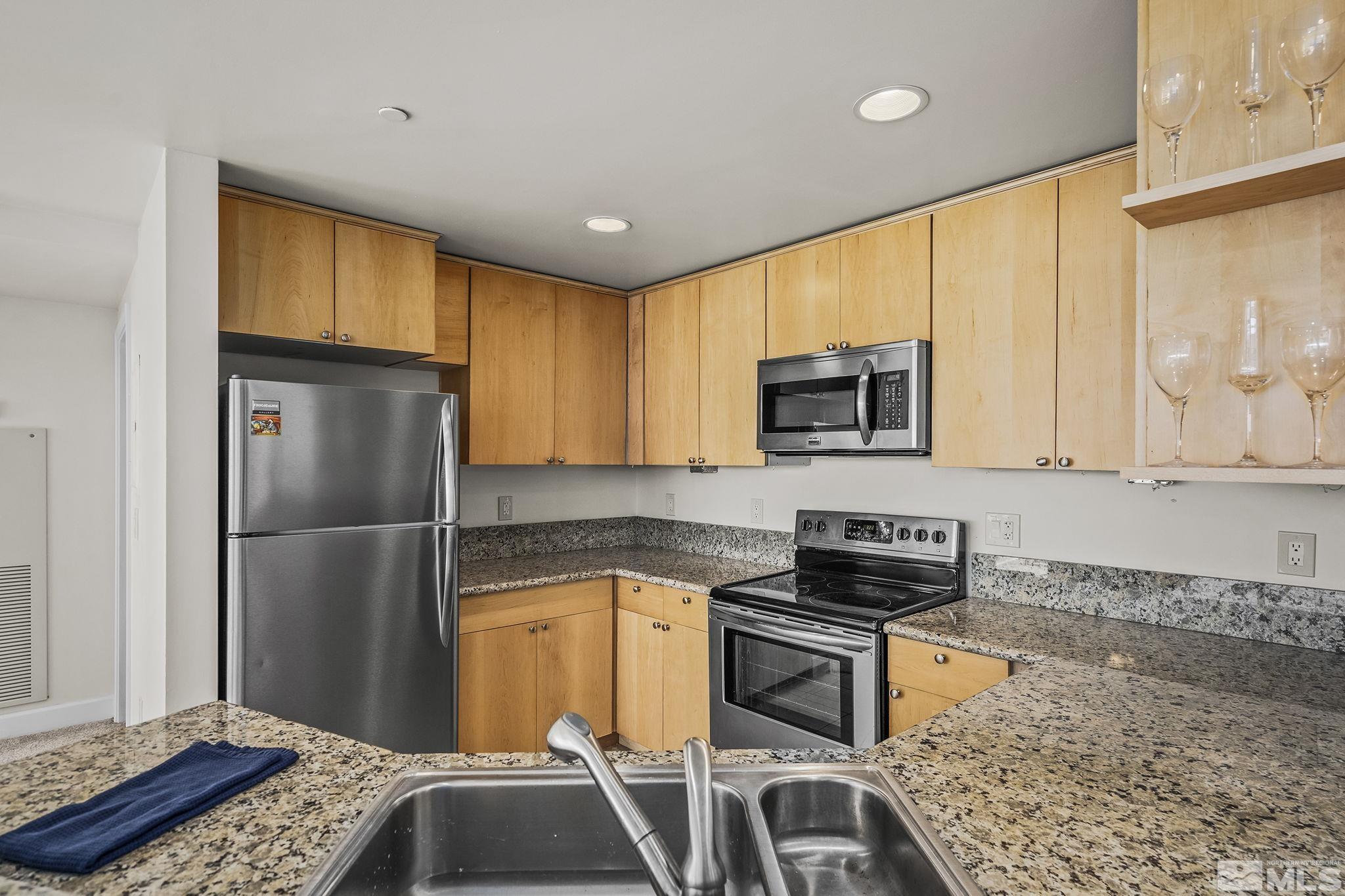 450 North Arlington Avenue, Unit 1207 Reno, NV 89503 - Photo 10 of 22 a kitchen with a refrigerator and a sink