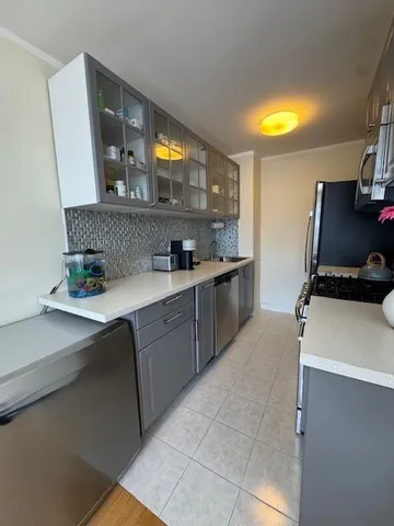 a kitchen with a sink appliances and cabinets