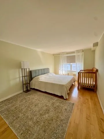 a spacious bedroom with a bed and window