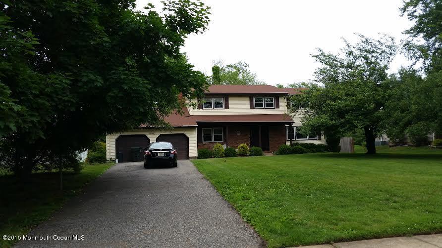 51 Hidden Stream Road Freehold, NJ 07728 - Photo 1 of 21 a view of a big house with a small yard and a large tree