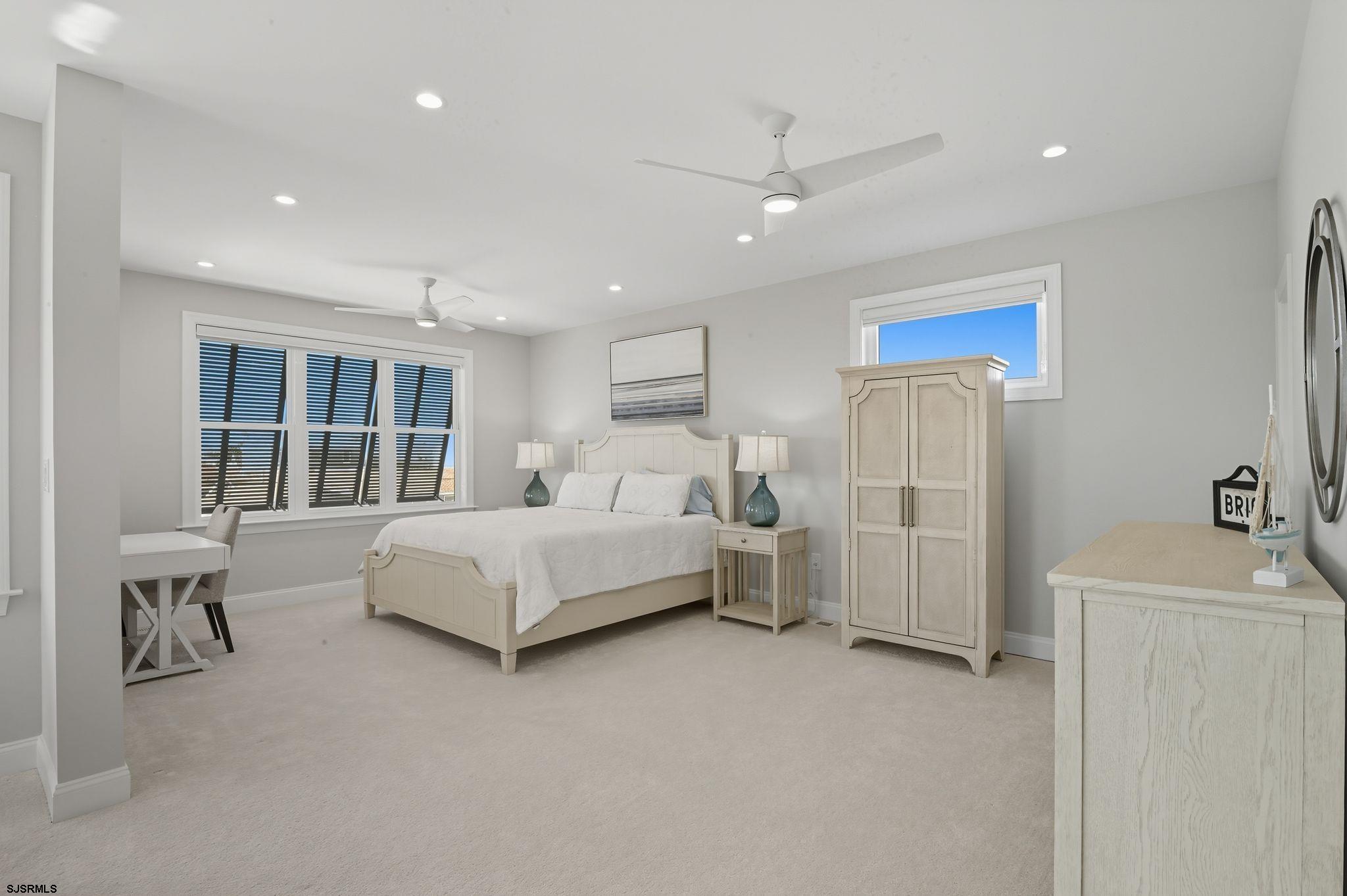 223 8th Street South Brigantine, NJ 08203 - Photo 13 of 46 a spacious bedroom with a bed and a large window