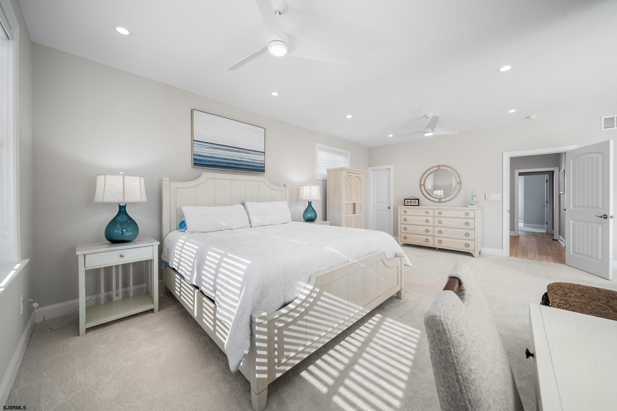 223 8th Street South Brigantine, NJ 08203 - Photo 14 of 46 a bedroom with a bed and a chandelier