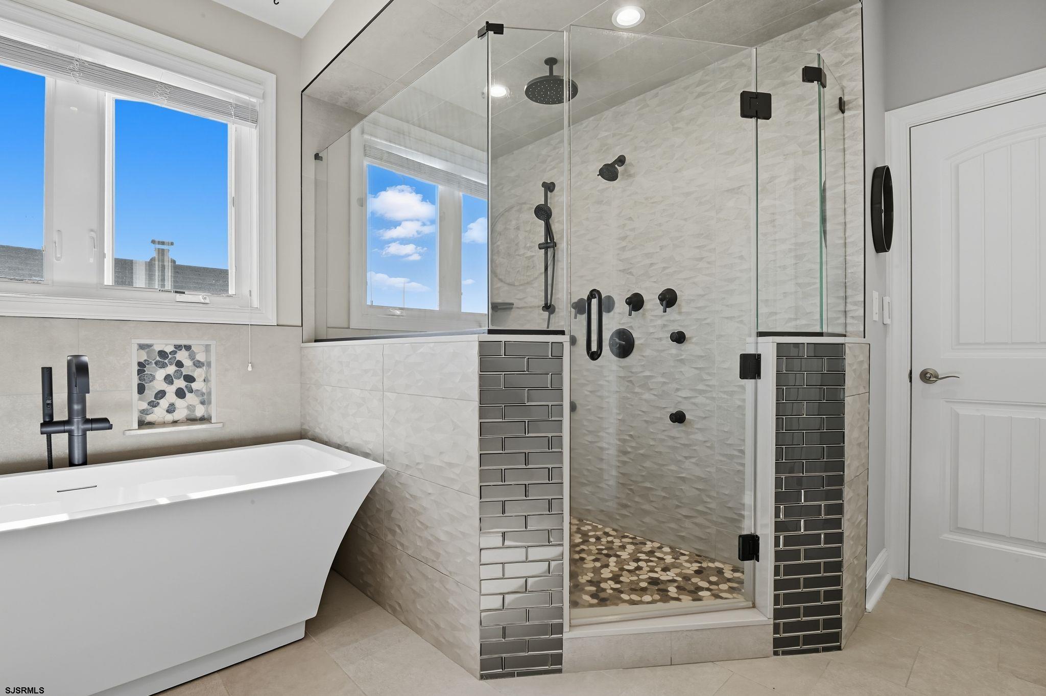 223 8th Street South Brigantine, NJ 08203 - Photo 19 of 46 a bathroom with a bathtub and shower