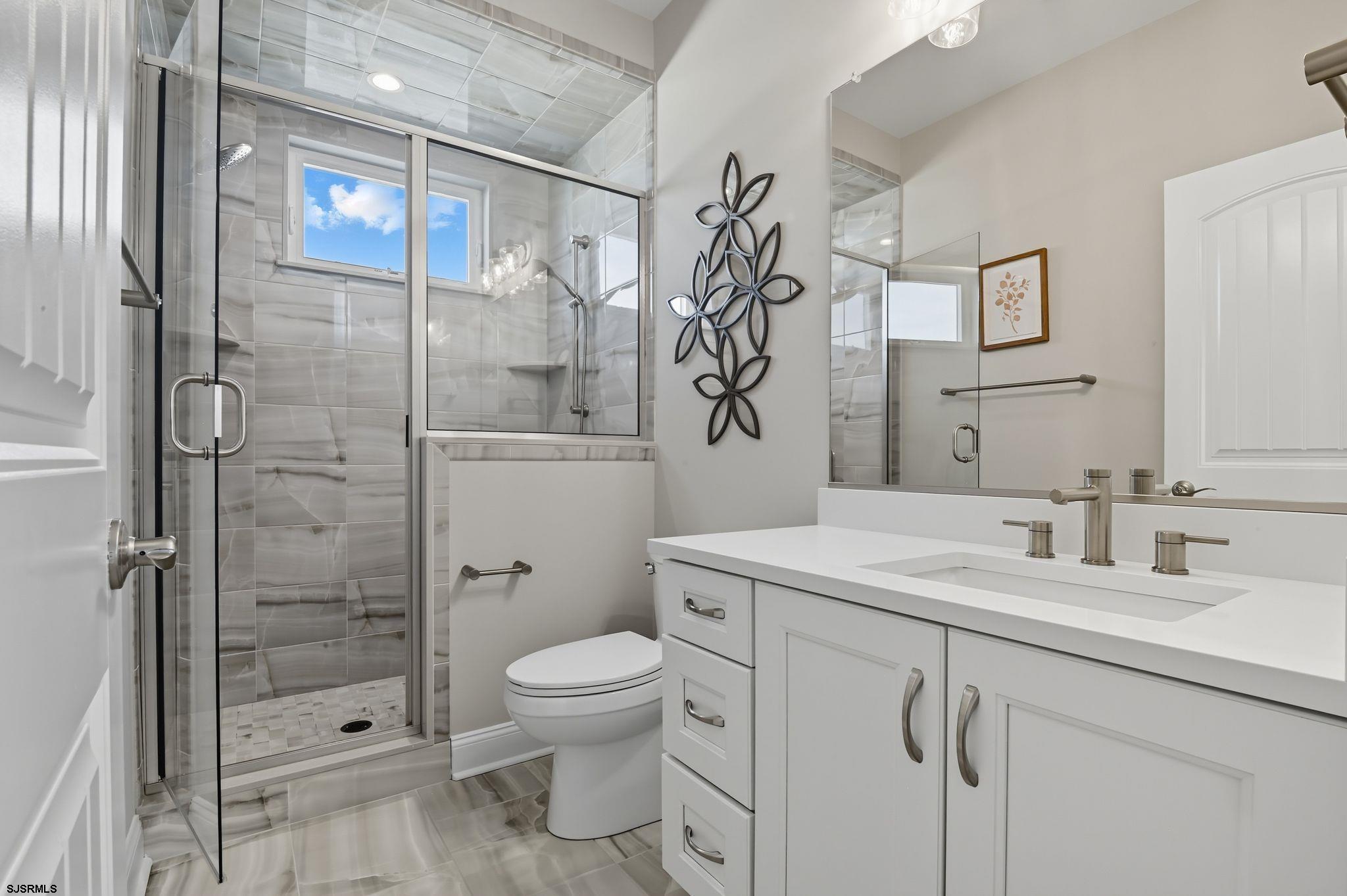 223 8th Street South Brigantine, NJ 08203 - Photo 22 of 46 a bathroom with a sink toilet and shower