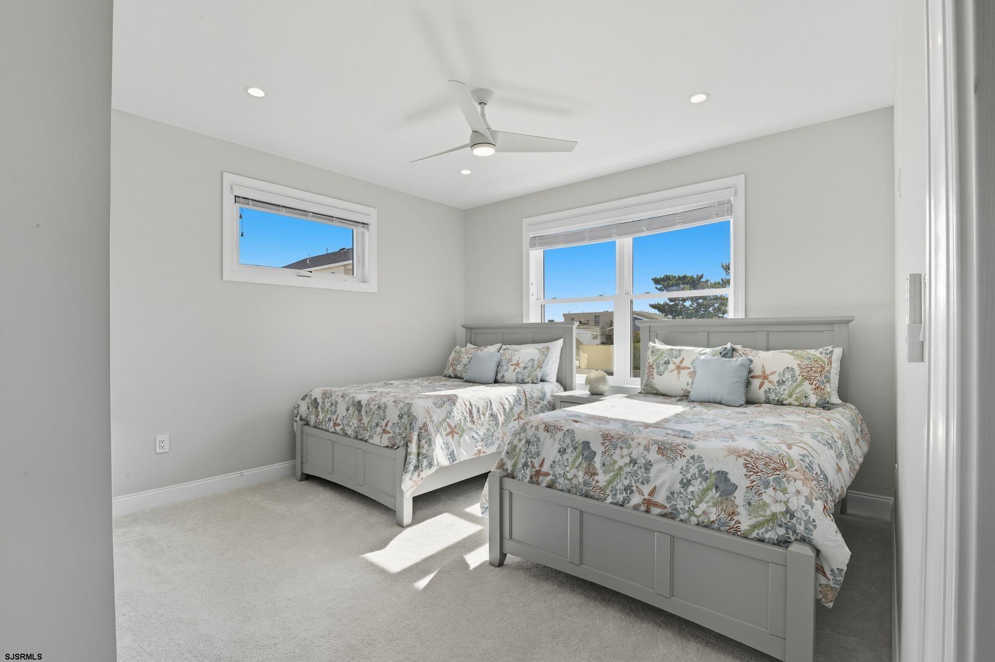 223 8th Street South Brigantine, NJ 08203 - Photo 23 of 46 a bedroom with double bed and a chandelier