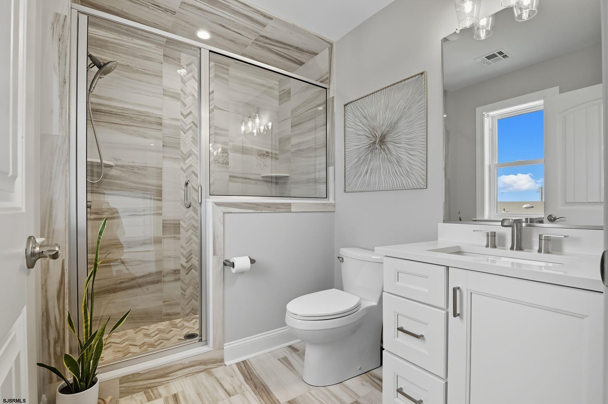 223 8th Street South Brigantine, NJ 08203 - Photo 25 of 46 a bathroom with a granite countertop sink toilet and shower