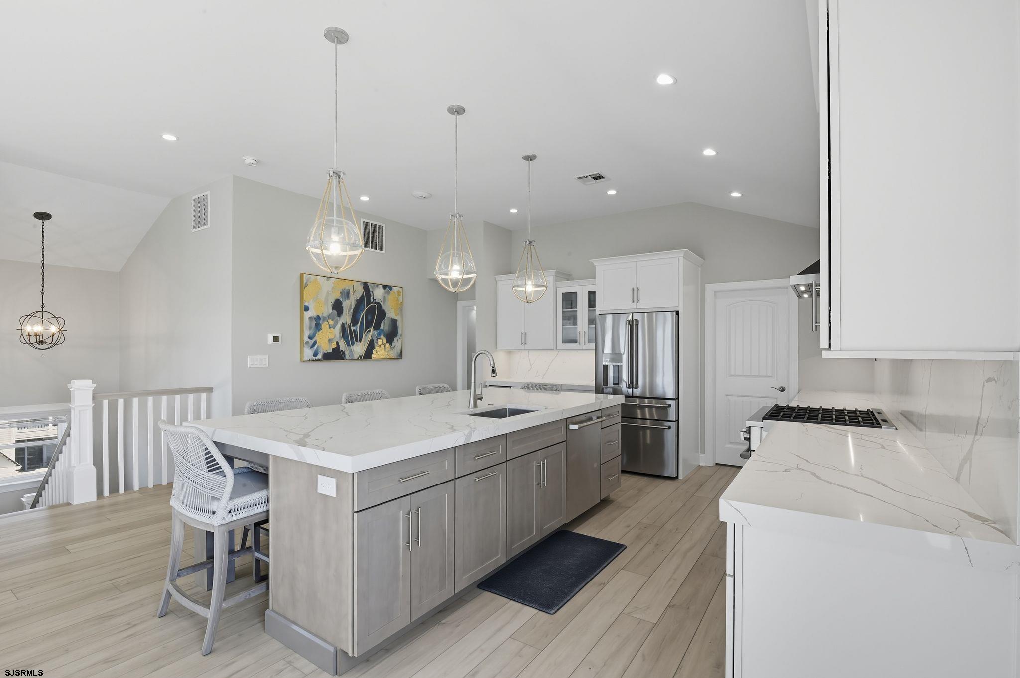 223 8th Street South Brigantine, NJ 08203 - Photo 26 of 46 a large kitchen with a table and chairs in it