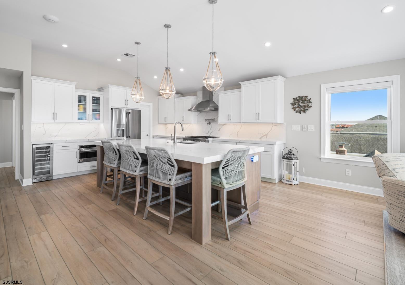 223 8th Street South Brigantine, NJ 08203 - Photo 27 of 46 a large kitchen with cabinets wooden floor and stainless steel appliances