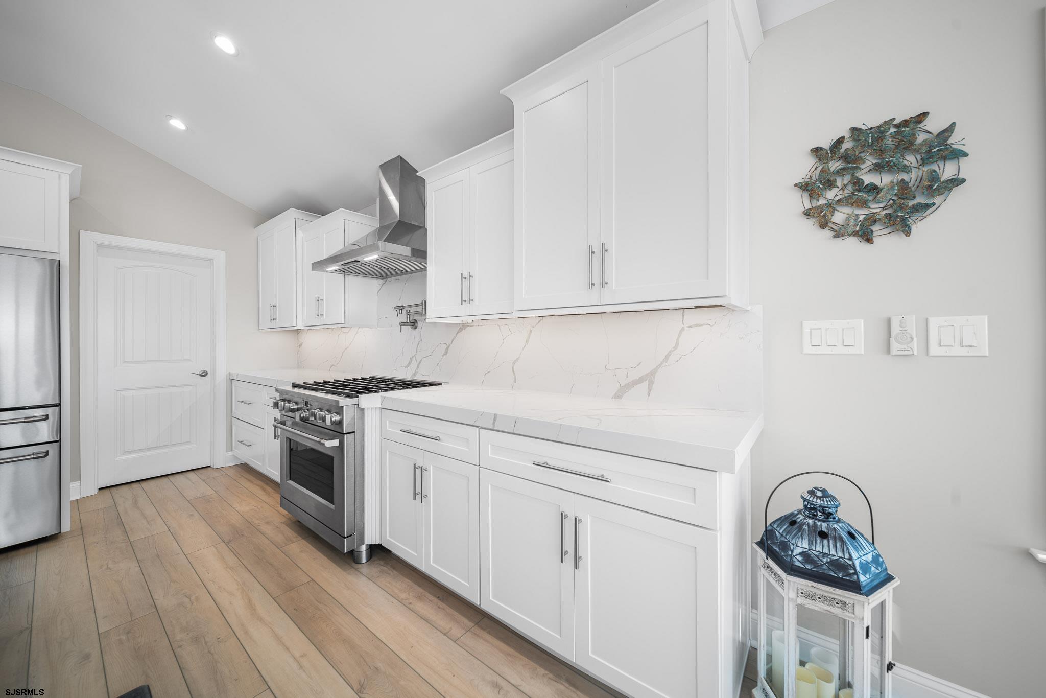 223 8th Street South Brigantine, NJ 08203 - Photo 29 of 46 a kitchen with cabinets and wooden floor