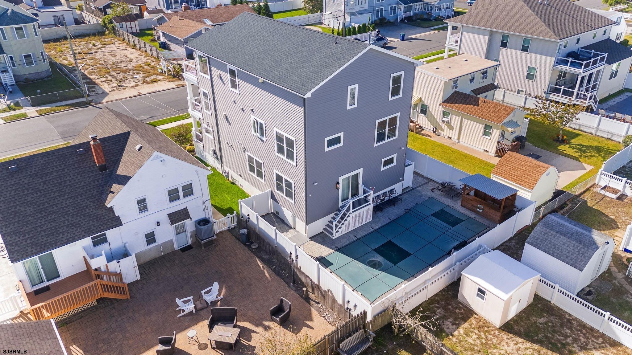223 8th Street South Brigantine, NJ 08203 - Photo 3 of 46 an aerial view of a house with a swimming pool and outdoor seating