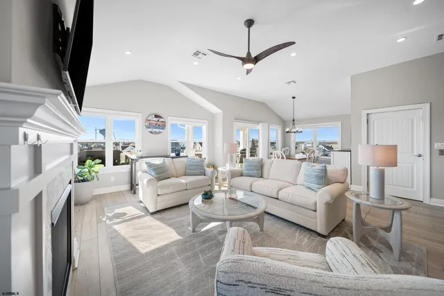 a living room with furniture fireplace and a flat screen tv