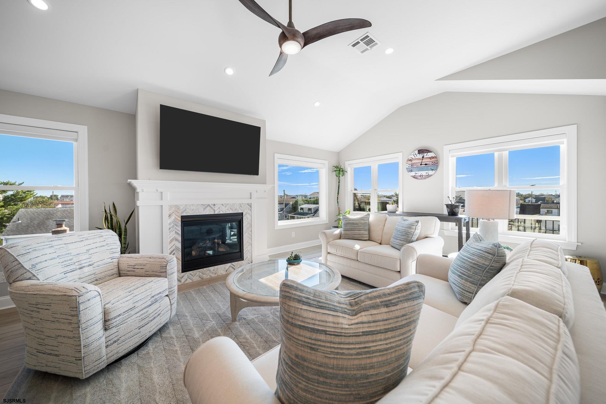 223 8th Street South Brigantine, NJ 08203 - Photo 32 of 46 a living room with furniture fireplace and a flat screen tv