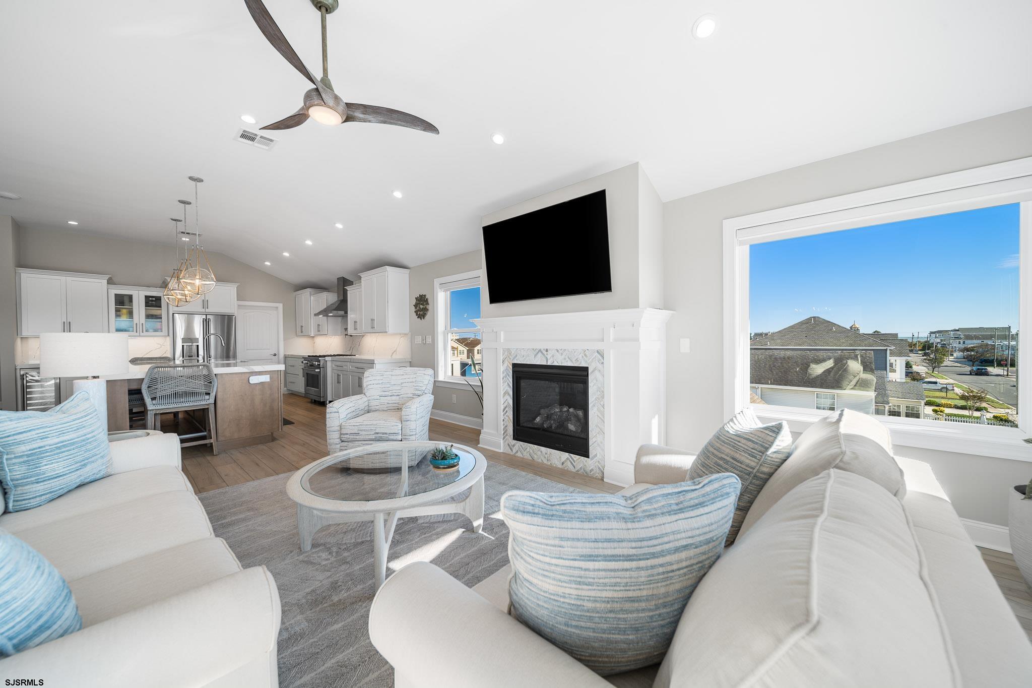 223 8th Street South Brigantine, NJ 08203 - Photo 33 of 46 a living room with furniture a fireplace and a flat screen tv