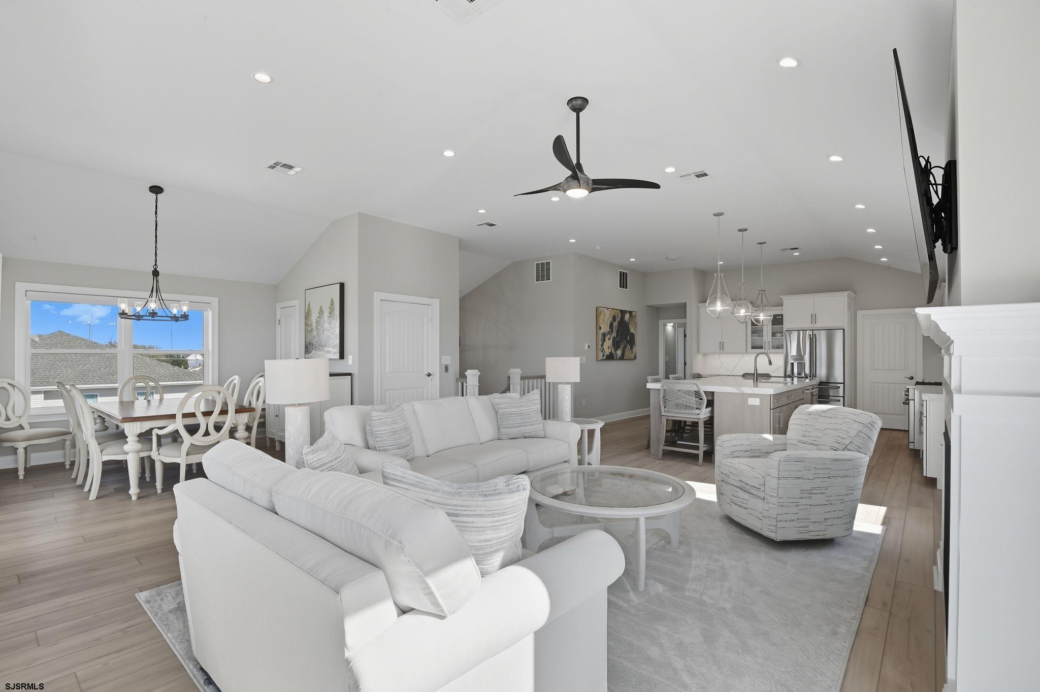 223 8th Street South Brigantine, NJ 08203 - Photo 36 of 46 a living room with furniture and a chandelier