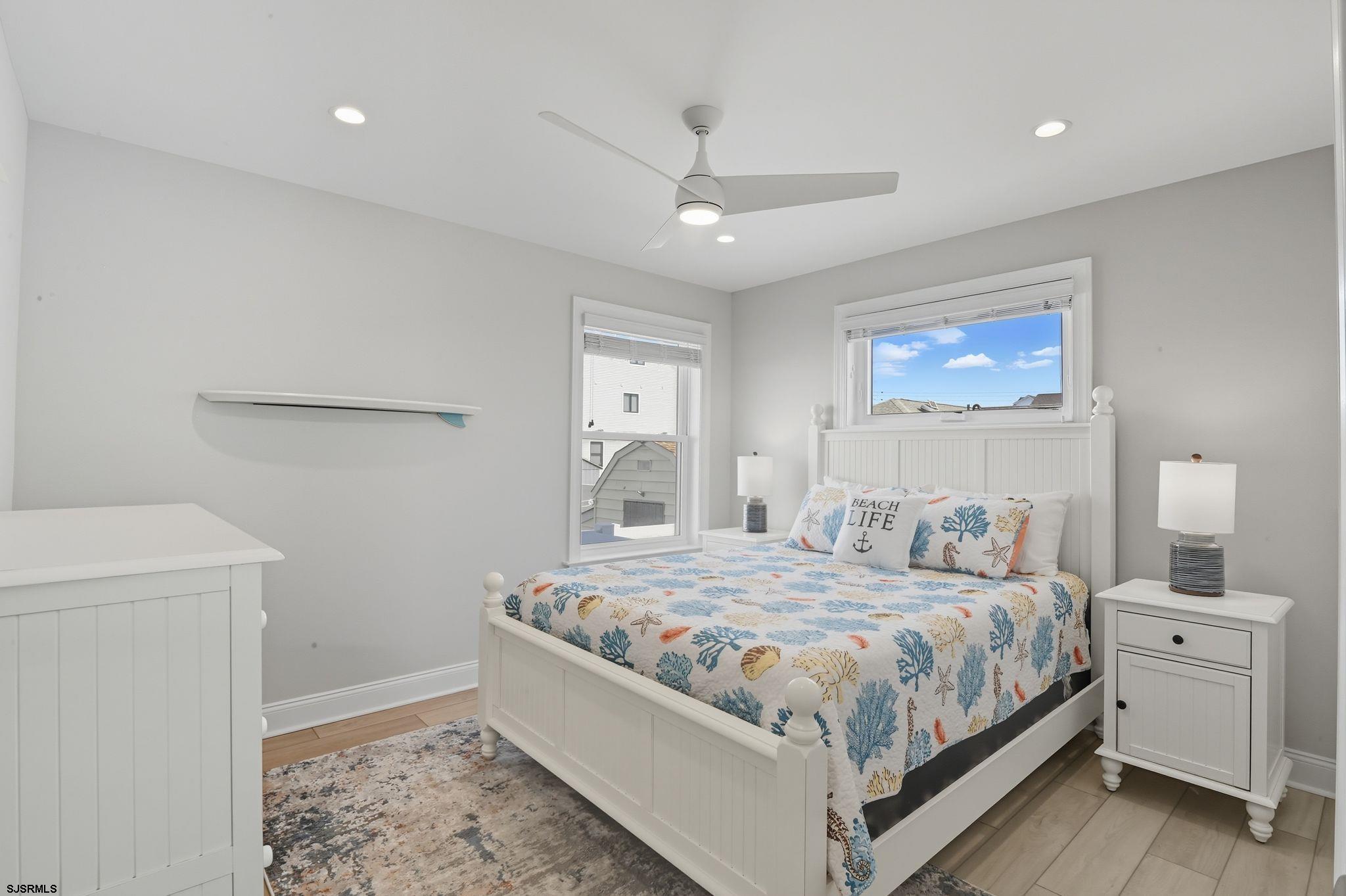 223 8th Street South Brigantine, NJ 08203 - Photo 7 of 46 a bedroom with a large bed and a window