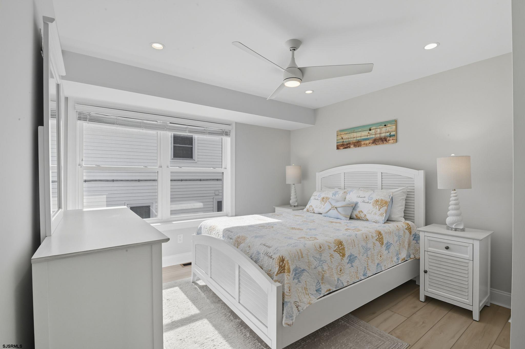 223 8th Street South Brigantine, NJ 08203 - Photo 9 of 46 a bedroom with a bed and a window