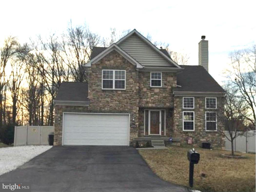 2416 Lodge Farm Road Baltimore, MD 21219 - Photo 1 of 12 a front view of a house with a yard and garage