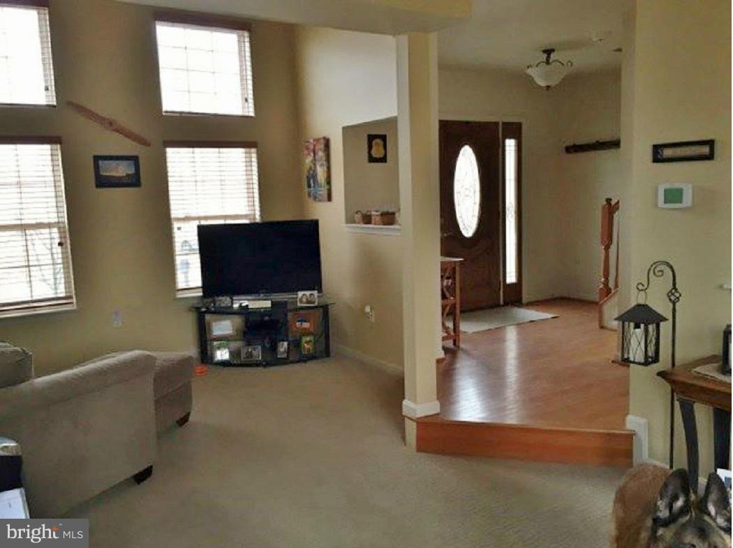 2416 Lodge Farm Road Baltimore, MD 21219 - Photo 2 of 12 a living room with furniture a flat screen tv and a window