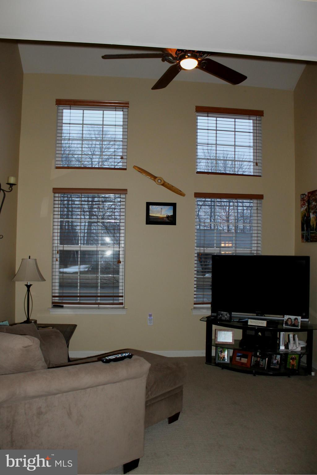 2416 Lodge Farm Road Baltimore, MD 21219 - Photo 5 of 12 a living room with furniture a flat screen tv and a window