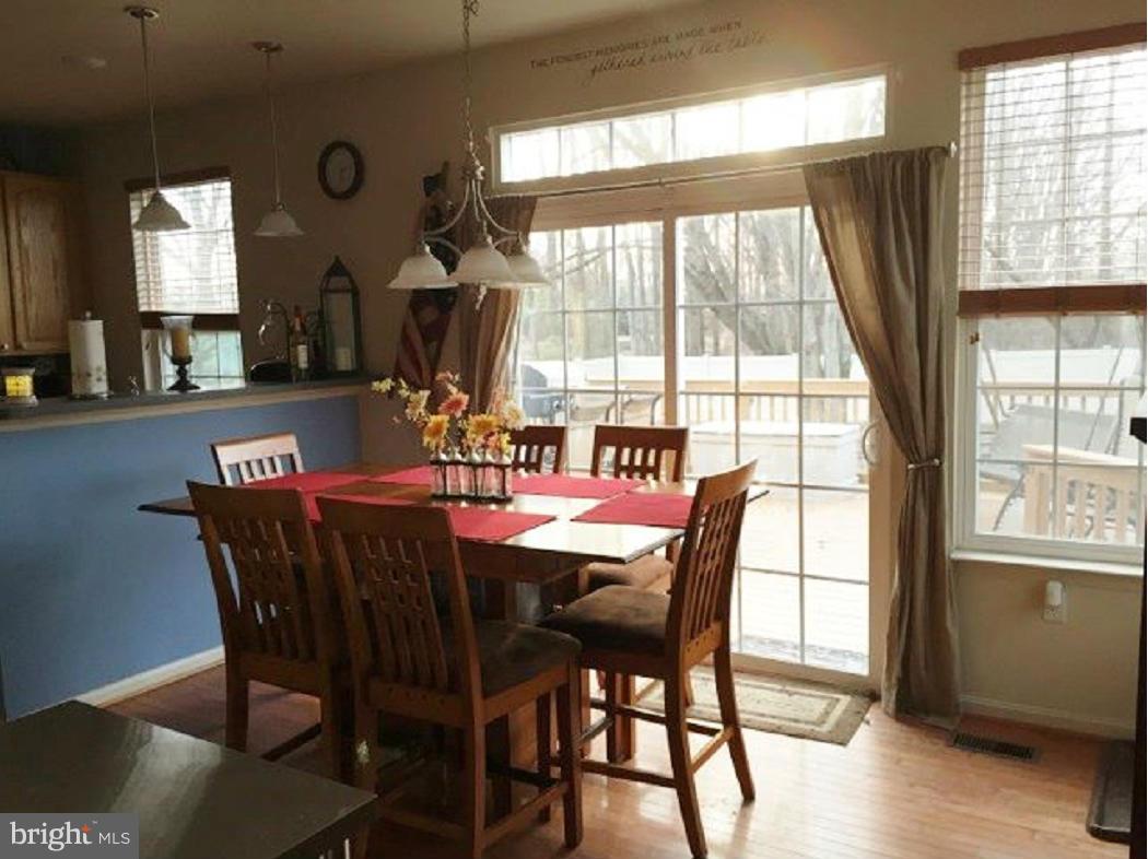 2416 Lodge Farm Road Baltimore, MD 21219 - Photo 6 of 12 a dining room with furniture window wooden floor