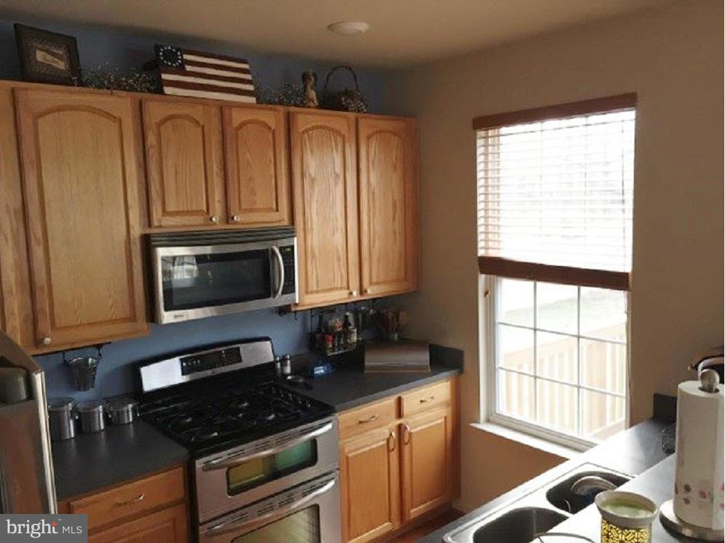 2416 Lodge Farm Road Baltimore, MD 21219 - Photo 7 of 12 a kitchen with granite countertop a stove and a microwave