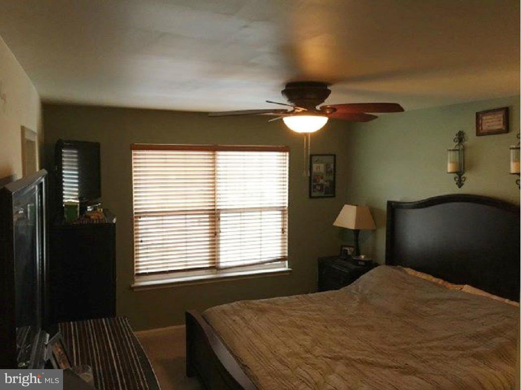 2416 Lodge Farm Road Baltimore, MD 21219 - Photo 10 of 12 a bedroom with a bed and a chandelier
