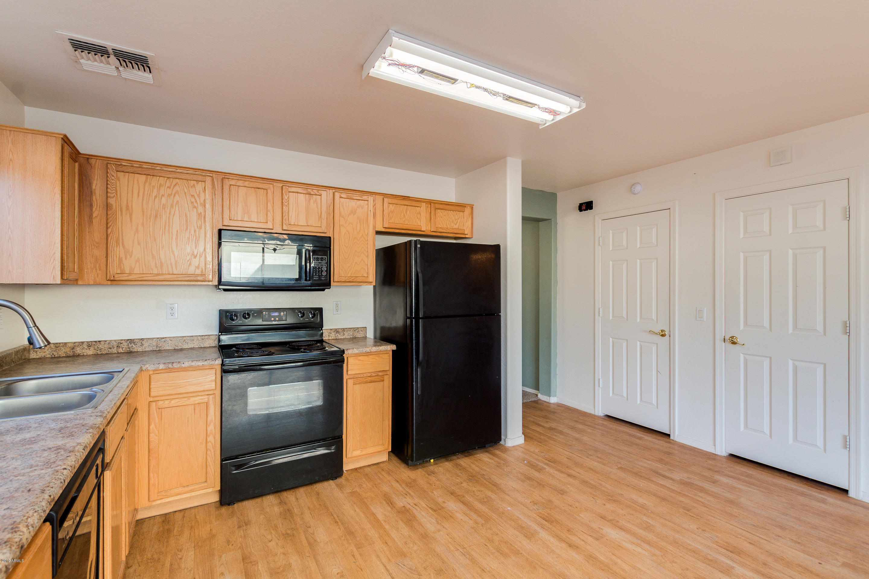 3732 West Fremont Rd. Phoenix, AZ 85041 - Photo 6 of 34 a kitchen with granite countertop a refrigerator stove top oven and sink