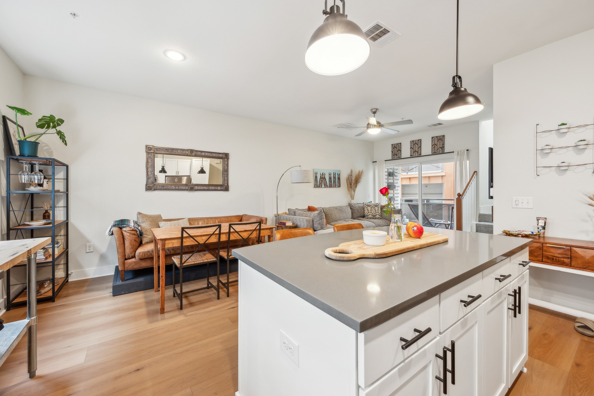 2827 Manor Road, Unit 3104 Austin, TX 78722 - Photo 2 of 30 Blonde hardwood floors complement a well-lit living area and kitchen with sleek island seating.