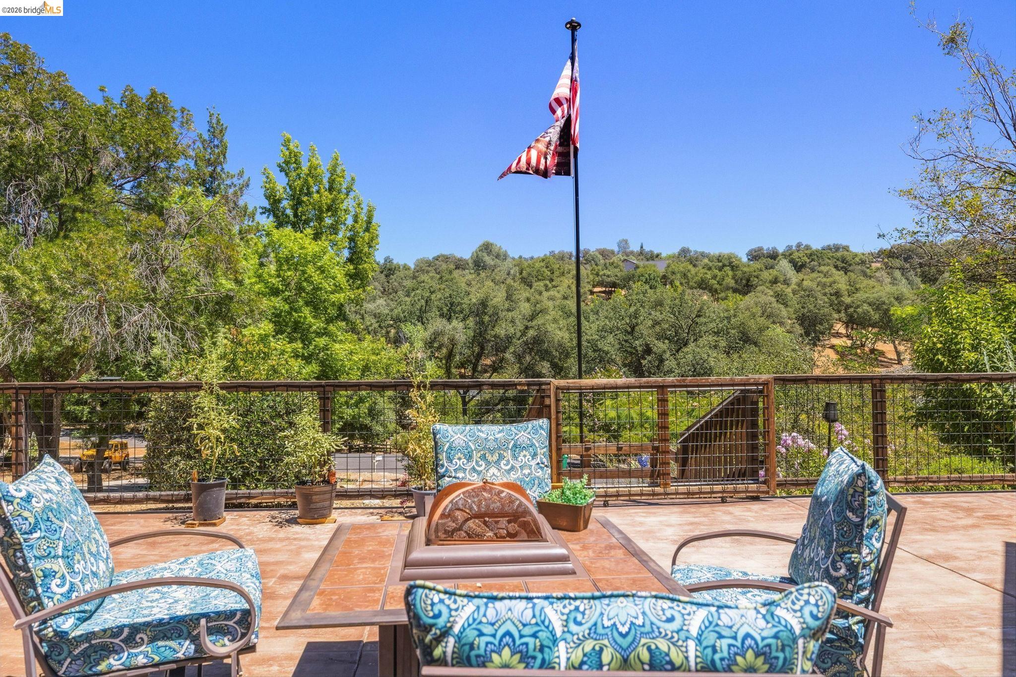 18570 Pradera Real Road Sonora, CA 95370 - Photo 11 of 66 Expansive outdoor deck with railing, featuring a concrete surface with ample room for seating