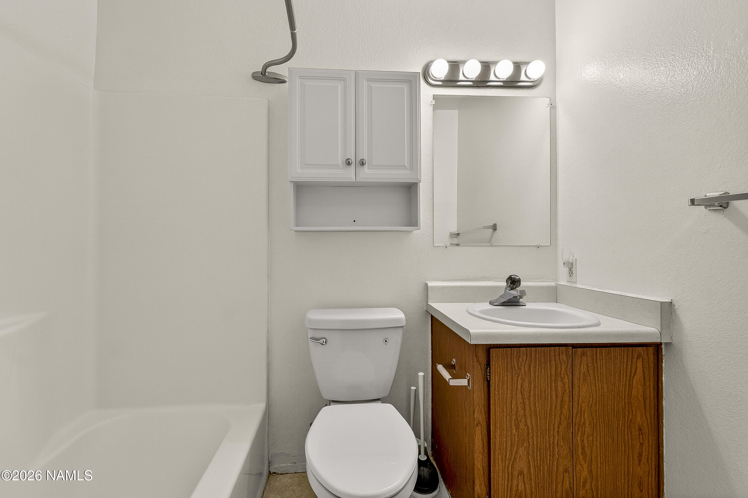 1200 South Riordan Ranch Street, Unit 112 Flagstaff, AZ 86001 - Photo 11 of 22 a bathroom with a toilet sink and mirror