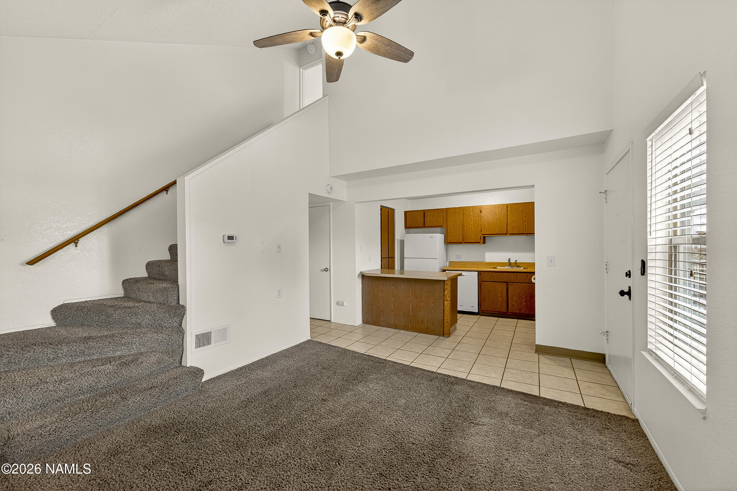 1200 South Riordan Ranch Street, Unit 112 Flagstaff, AZ 86001 - Photo 4 of 22 a view of an empty room with wooden floor and a window