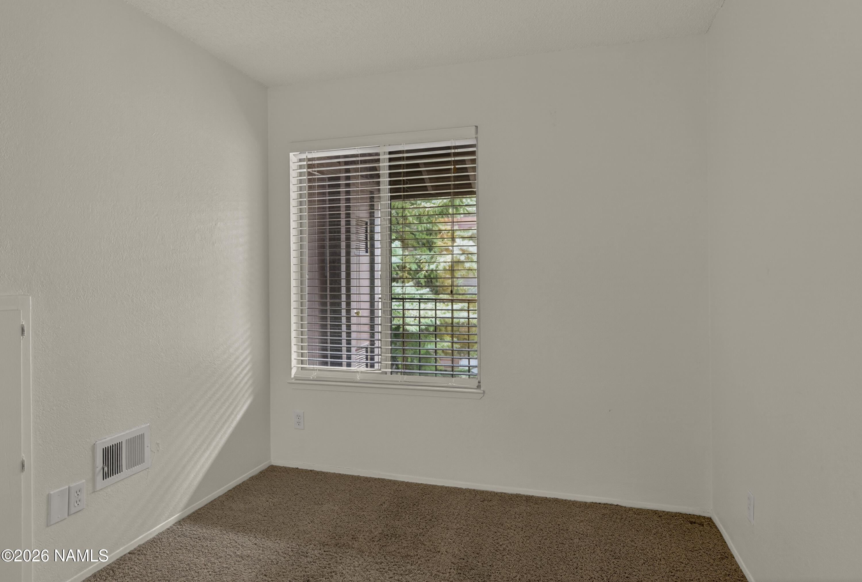 1200 South Riordan Ranch Street, Unit 112 Flagstaff, AZ 86001 - Photo 10 of 22 a view of an empty room with a window