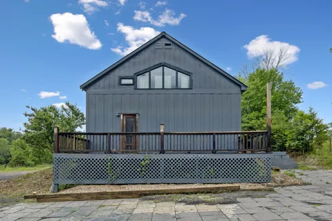 a view of balcony with wooden floor and fence