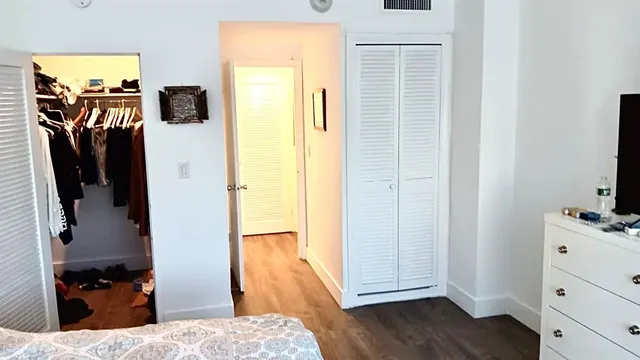 a view of a bedroom from a corridor