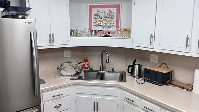 a kitchen with white cabinets and a sink