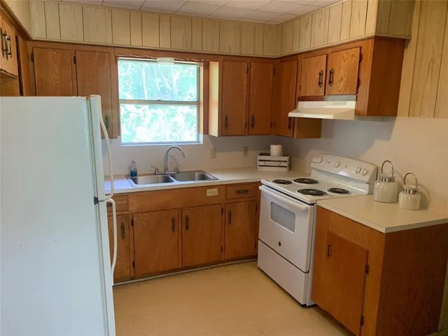 a kitchen with a sink cabinets and window