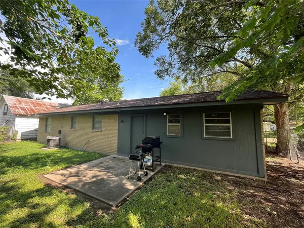 a backyard of a house with table and chairs
