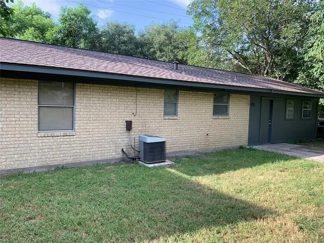 a backyard of a house with table and chairs