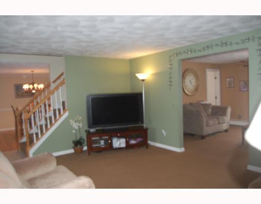 169 Lonsdale Farm Road Cumberland, RI 02864 - Photo 12 of 12 Living Room. Reverse view of living room, family room combination, displays the comforting decor and openess of the floor plan
