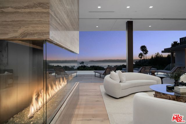 a view of a patio with couches and table and chairs and potted plants
