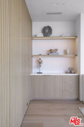 a bedroom with a bed and painting on the wall