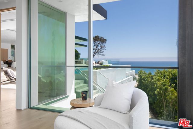 a living room with furniture and view of kitchen